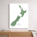 Map of New Zealand on a white wall above a wooden shelf.