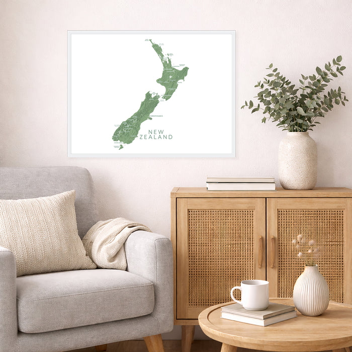 Living room with a map of New Zealand on the wall, a vase with plants, and a wooden cabinet.