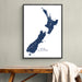 Framed map of New Zealand on a wall above a wooden bench.