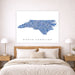Framed map of North Carolina above a bed in a bedroom setting
