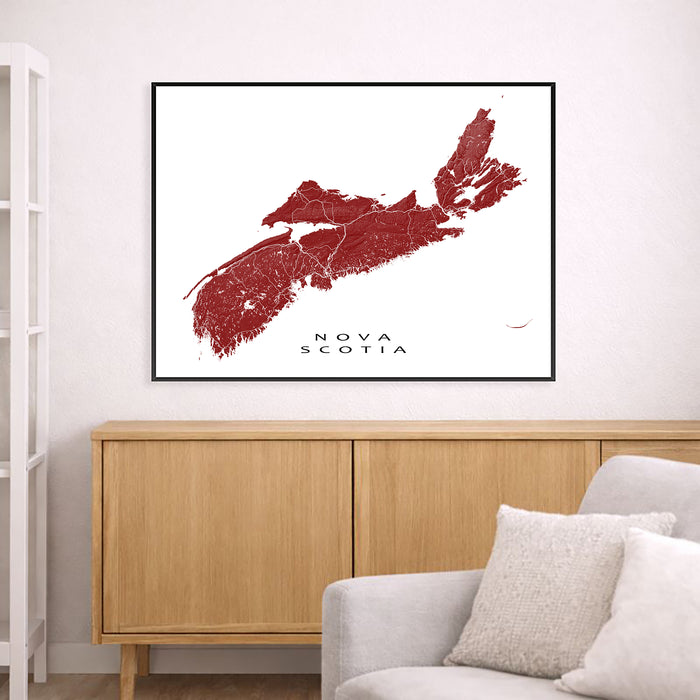 Map of Nova Scotia framed on a wall above a wooden cabinet and sofa.