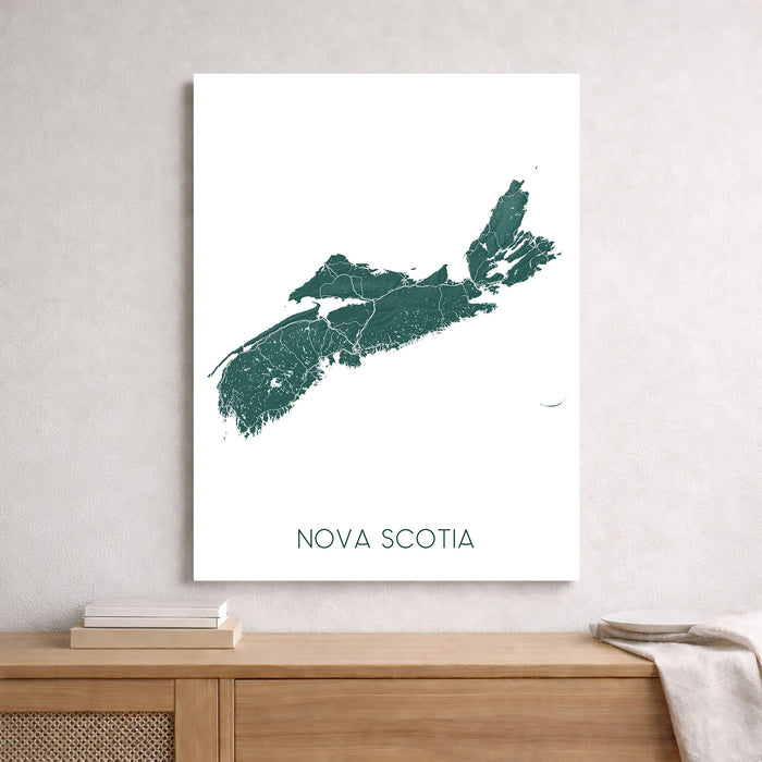 Map of Nova Scotia on a white background, framed on a wall above a wooden shelf.
