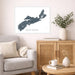 Framed map of Nova Scotia on a wall above a sofa in a living room.