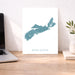 Map of Nova Scotia on a desk with a laptop and plant