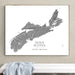 A framed custom topographic map print of Nova Scotia, featuring gray landforms on a white background with the text 'NOVA SCOTIA' and 'SMITH FAMILY - SYDNEY 2022-2026'. The framed print is displayed on a beige wall above a white bench with a light blue draped cloth.