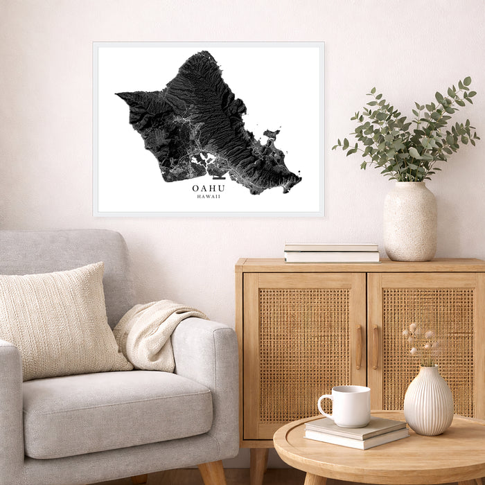 Framed map of Oahu on a wall above a sofa in a living room.