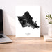Map of Oahu, Hawaii on a white background with a laptop and plant in the background.