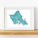 Framed map of Oahu, Hawaii on a white wall.