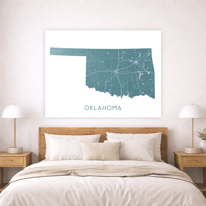 Map of Oklahoma on a wall above a bed in a bedroom setting