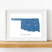 Framed map of Oklahoma on a white wall