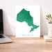 Map of Ontario on a white background next to a laptop on a wooden desk.