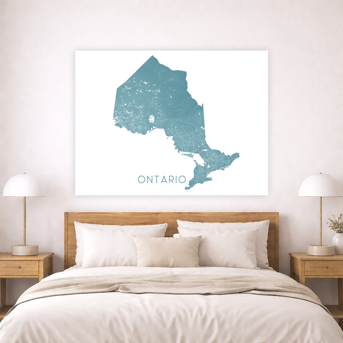 Map of Ontario on a wall above a bed in a bedroom