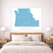 Bedroom with a map of the Pacific Northwest on the wall above a bed.