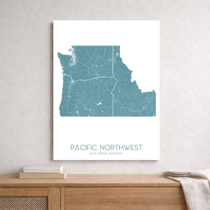 Map of the Pacific Northwest on a white wall above a wooden shelf.