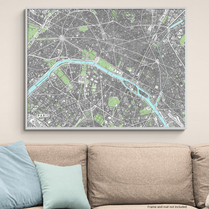 City map of Paris on a wall above a beige sofa with blue cushions.