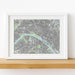 Framed city map print on a wooden shelf