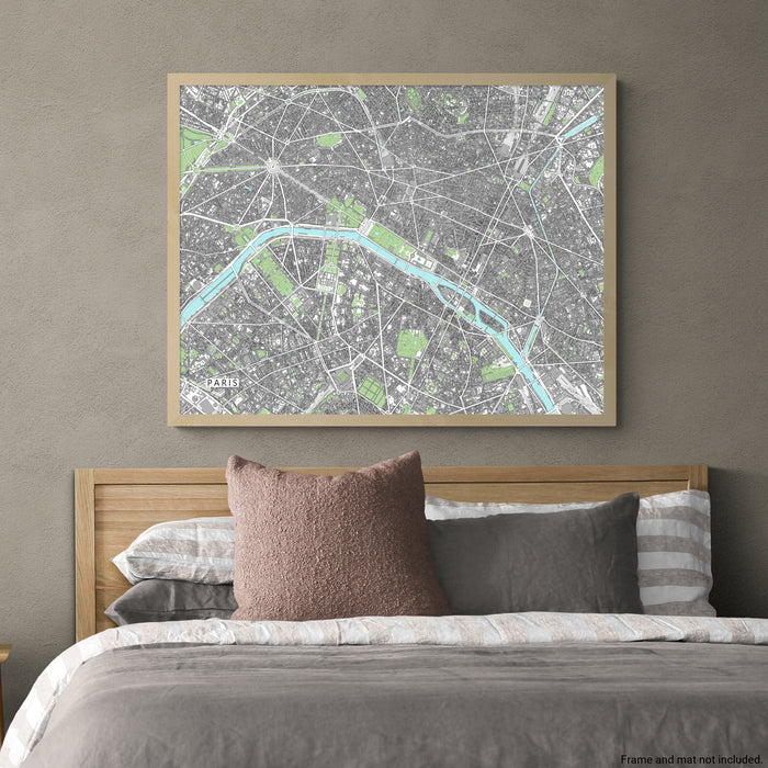 Framed city map above a bed with pillows