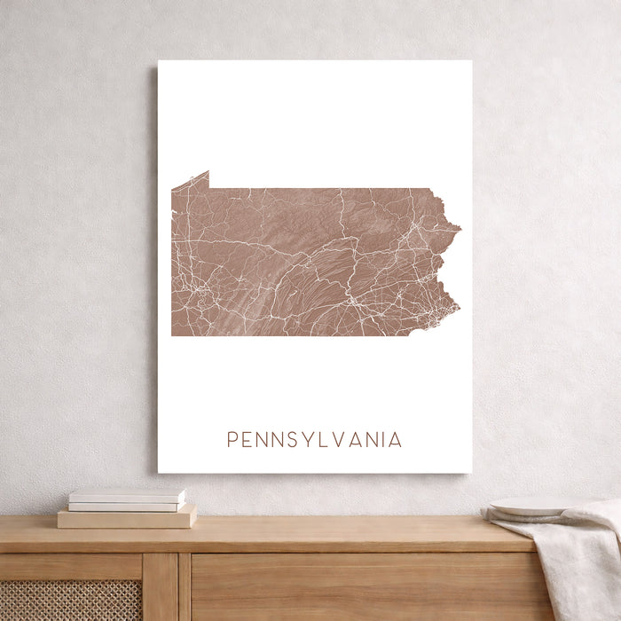Map of Pennsylvania on a white wall above a wooden shelf.