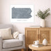 Framed map of Pennsylvania on a wall above a sofa in a living room.