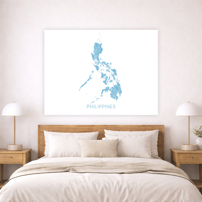 Bedroom with a map of the Philippines on the wall above a bed.