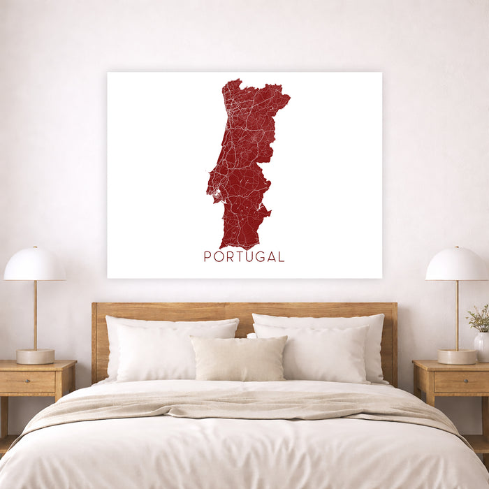 Map of Portugal on a wall above a bed in a bedroom setting