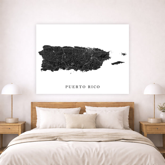Map of Puerto Rico on a wall above a bed in a bedroom setting