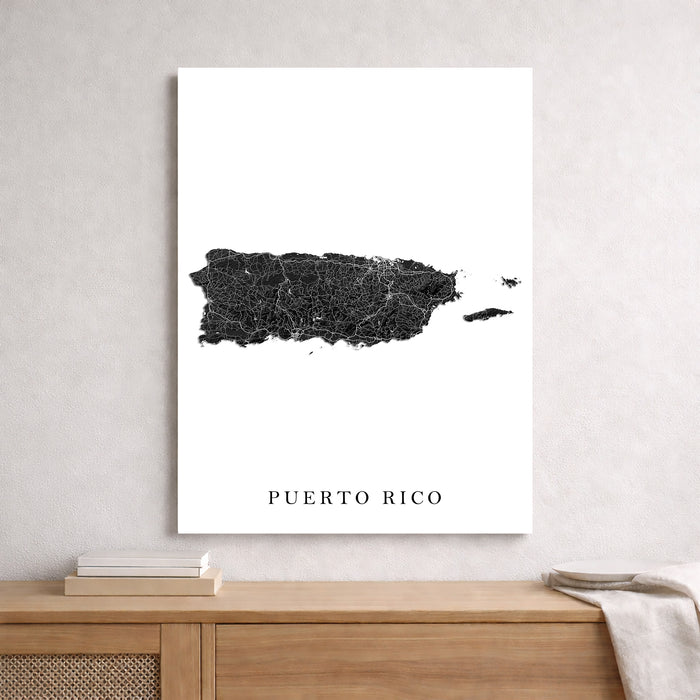 Map of Puerto Rico on a white wall above a wooden shelf.
