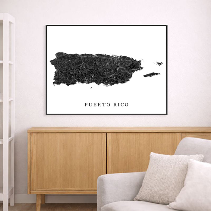 Framed map of Puerto Rico on a wall above a wooden cabinet and sofa.