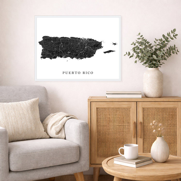 Living room with a map of Puerto Rico on the wall, a couch, and a wooden cabinet.