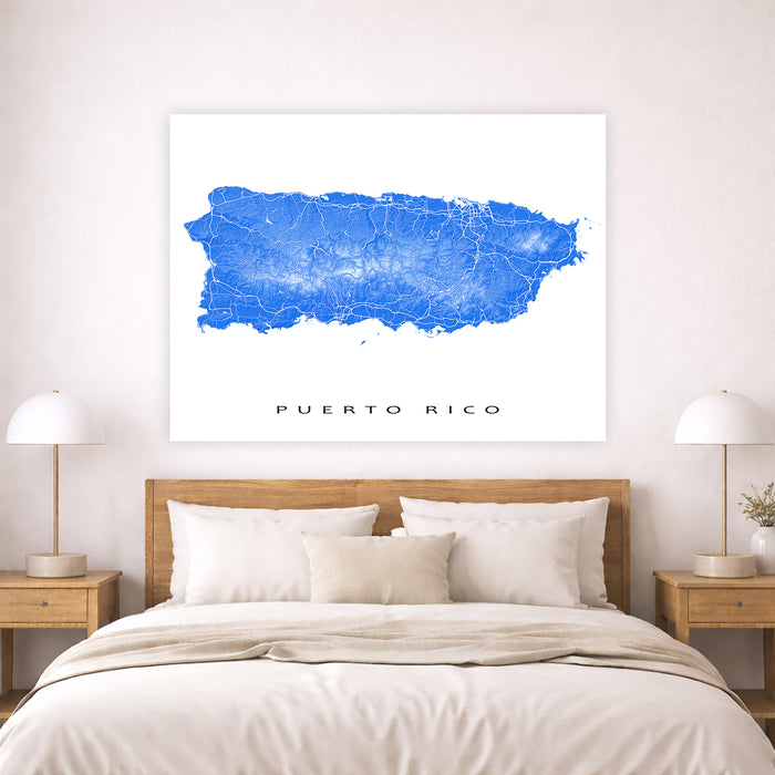 Map of Puerto Rico on a wall above a bed in a bedroom setting