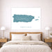Framed map of Puerto Rico on a wall above a bed in a bedroom.