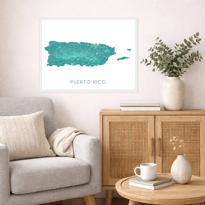 Living room with a gray sofa, wooden cabinet, and a framed map of Puerto Rico on the wall.