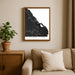 Framed map of Punta Cana on a wall above a beige sofa with a plant beside it.