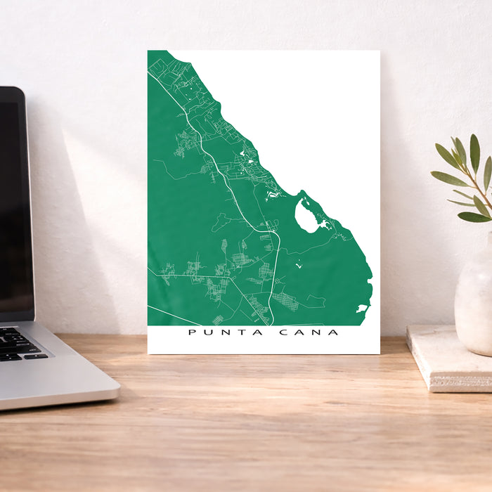 Map of Punta Cana on a desk with a laptop and plant