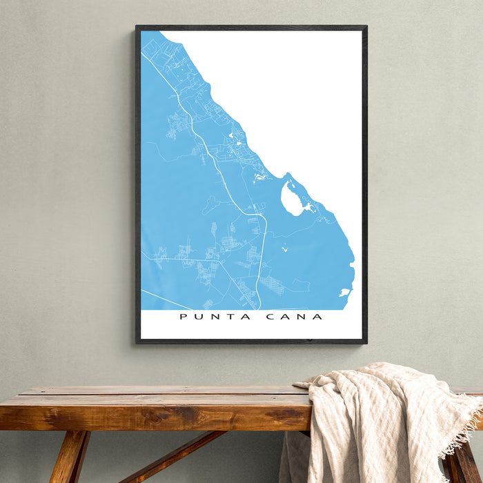 Framed map of Punta Cana on a wall above a wooden bench.