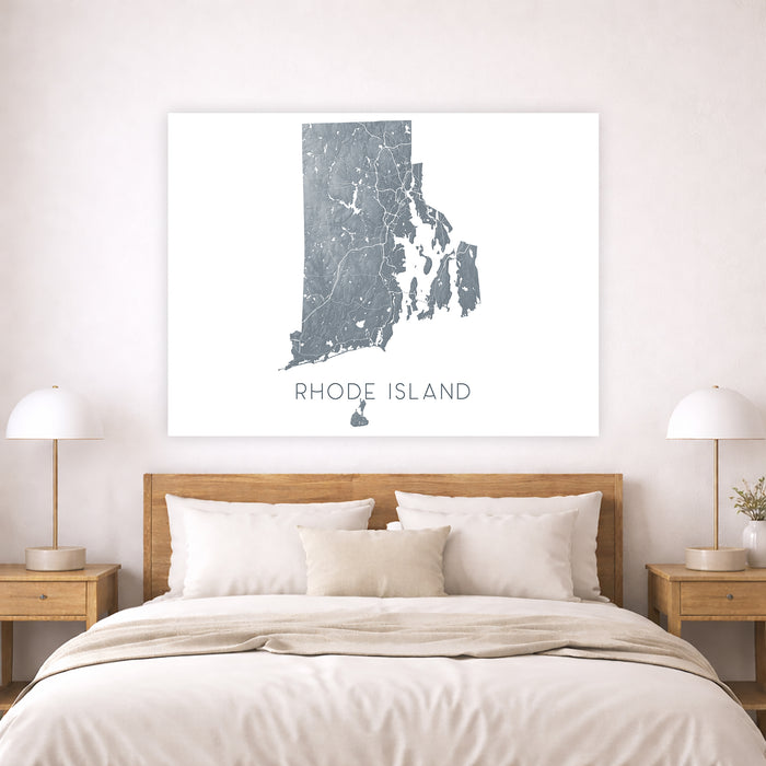 Framed map of Rhode Island above a bed in a bedroom setting