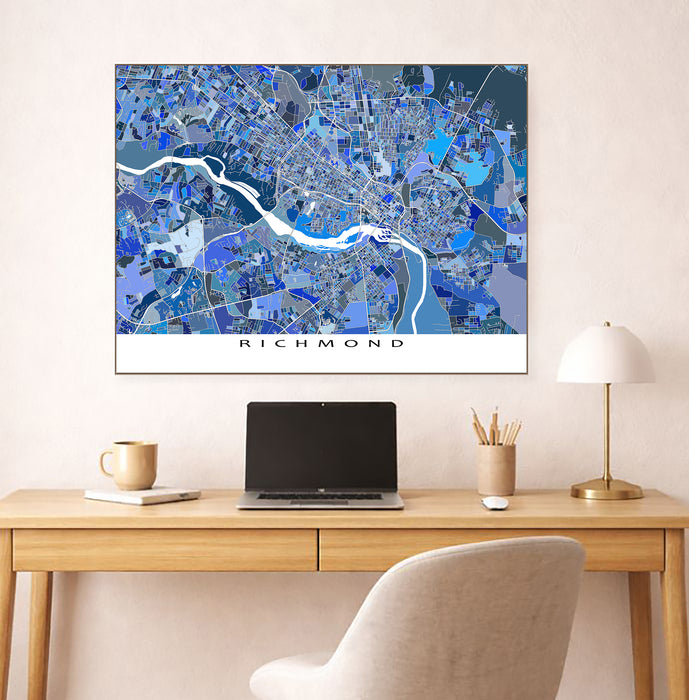 Map of Richmond on a wall above a desk with a laptop and lamp.