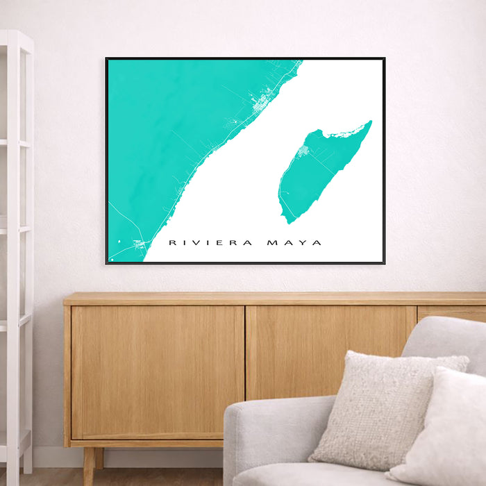 Framed map of Riviera Maya on a wall above a wooden cabinet and gray sofa.
