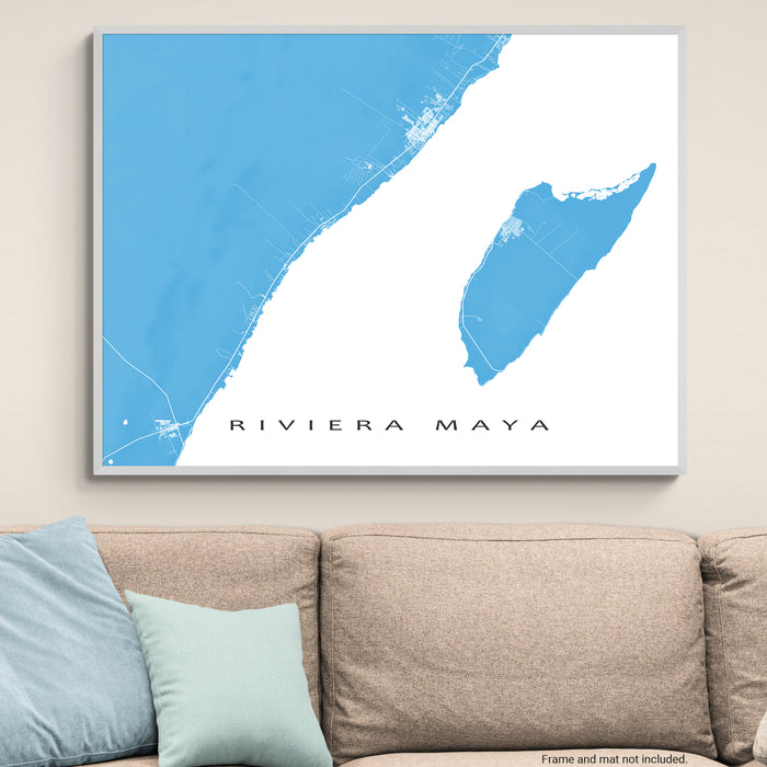Map of Riviera Maya on a wall above a beige sofa with light blue pillows.