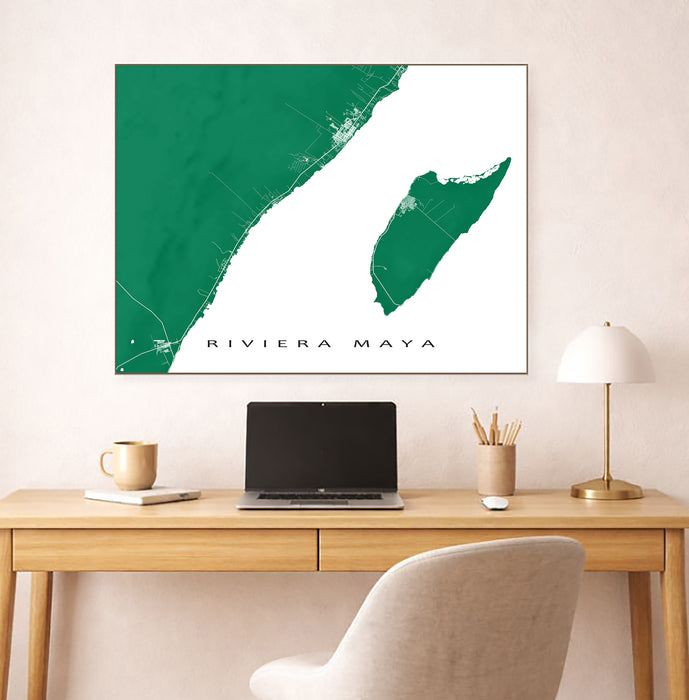 Map of Riviera Maya on a wall above a desk with a laptop and lamp.