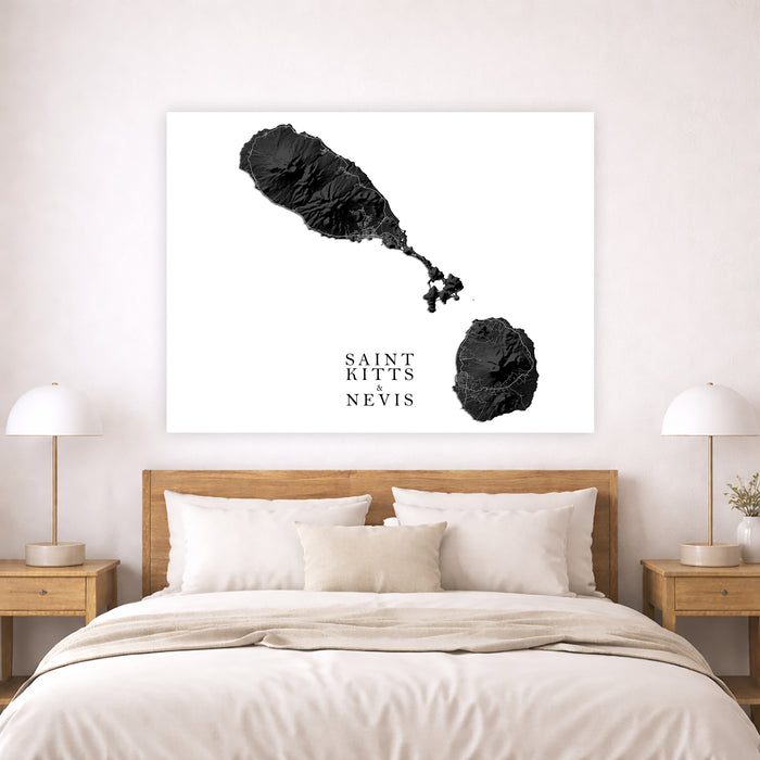 Framed artwork of Saint Kitts and Nevis on a wall above a bed.
