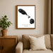 Framed artwork of Saint Kitts and Nevis on a wall above a sofa with a plant beside it.