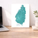 Map of Saint Lucia on a white background next to a laptop and plant.
