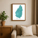 Framed map of Saint Lucia on a wall above a sofa with a plant beside it.