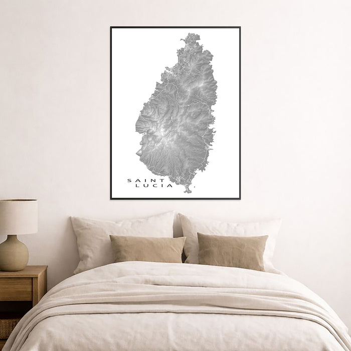 Framed map of Saint Lucia on a wall above a bed in a bedroom.