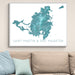 Framed map of Saint-Martin & Sint Maarten on a wall above a beige sofa with light blue pillows.