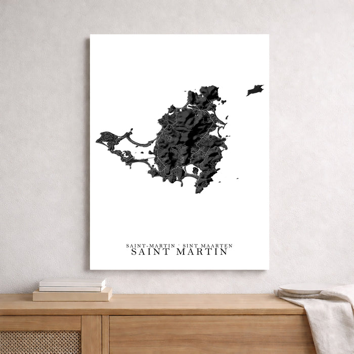 Map of Saint Martin on a white wall above a wooden shelf.