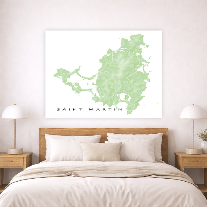 Map of Saint Martin on a wall above a bed in a bedroom setting