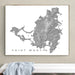 Framed map of Saint Martin on a wall above a white surface.