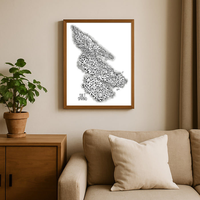 Framed black and white abstract art piece on a wall above a beige sofa with a plant beside it.